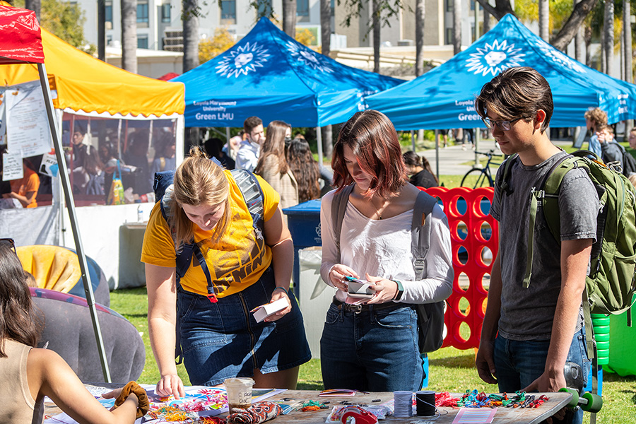 student purchasing fruit at a vendor booth